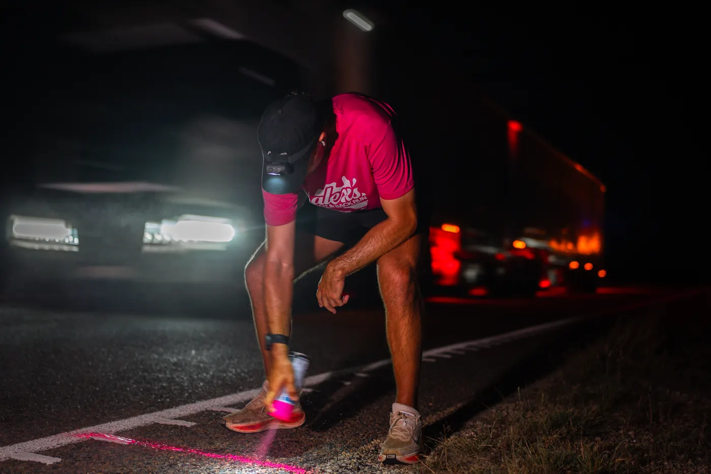 Alex Barbas marking the route at night with his support crew during his run across Australia